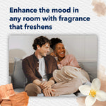 Lifestyle image of a smiling couple on a sofa with headline about enhancing the mood in any room with fragrance that freshens.