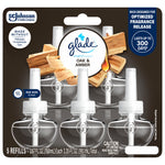 Front blister-pack image of Glade Oak & Amber plug-in refills showing five clear bottles and product branding