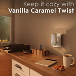 Lifestyle shot of a Glade plugIn warmer plugged into a wall in a cozy room with text promoting Vanilla Caramel Twist