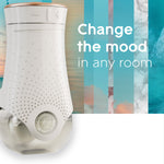 close-up of a white glade plugins scented oil warmer with text reading change the mood in any room over blue ocean-themed stripes