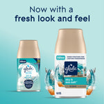Two Glade Sky & Sea Salt automatic spray refills shown on a teal background with text 'Now with a fresh look and feel'