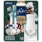 Close-up blister pack of Glade PlugIns Twinkling Pine & Cedar showing white warmer, two refills and holiday pine cone artwork