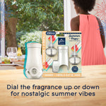 Lifestyle image of Glade warmer and Summer Pops starter kit on a table with blurred outdoor greenery and person in background