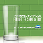 Tall clear drinking glass on green tiled background with text about improved formula and a Dawn logo