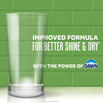 Tall clear glass on a green tiled background with text about improved formula and a Dawn logo at the corner