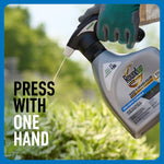 Gloved hand pressing Roundup QuickHand sprayer attached to refill bottle, liquid spraying toward grass with caption “Press with one hand”