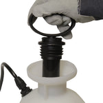 Gloved hand holding the black pump handle of a Chapin sprayer inserted into the tank neck for pumping action