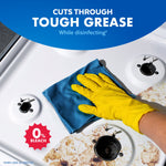 Hand in yellow glove wiping a greasy stovetop with a blue cloth and a 0% bleach icon promoting grease-cutting power