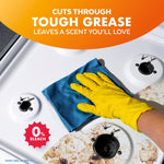 Hand wearing yellow glove wiping a dirty stove surface with a blue cloth and orange banner reading cuts through tough grease