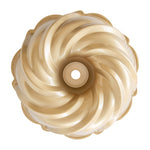 Top-down view of a gold nonstick swirl bundt pan showing the interior decorative ridges and center tube