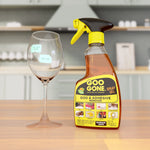 Goo Gone spray gel bottle staged on a kitchen counter next to a wine glass with price stickers, product label clearly visible.