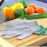 Gray knit glove placed on a cutting board with colorful bell peppers and chives in background