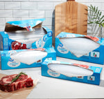 Staged kitchen scene with multiple Great Value freezer bag boxes and open boxes of clear gallon bags near raw steaks.