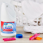 Great Value Low-Splash Bleach jug staged beside a laundry basket and clothespins in a lifestyle laundry scene