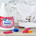 Great Value Low-Splash Bleach bottle beside a laundry basket, clothespins and folded towels on a table