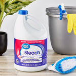 Great Value Bleach jug staged with cleaning supplies and plant, showing product label and blue cap