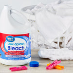 Great Value Low-Splash Bleach jug staged next to a laundry basket and clothespins on a table