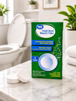 Lifestyle scene with Great Value Toilet Bowl Bleach Tabs box and two white tablets on a bathroom counter, toilet blurred in background