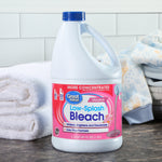 Great Value Low-Splash Bleach bottle placed on a counter with folded towels and baby clothing in the background