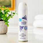 Great Value Blooming Lavender aerosol air freshener can styled on a countertop with blurred plant and towels in background.