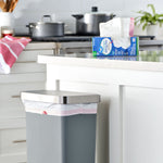 Kitchen scene with a Great Value trash bag box on the counter and a lined trash can in the foreground