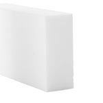 Close-up view of a single white cleaning eraser block showing texture and sharp edges on a white background.