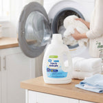 Great Value Free & Delicate unscented laundry detergent bottle placed on a countertop in a laundry room scene with folded towels.