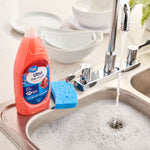 Great Value Ultra Dish Liquid bottle sitting by a kitchen sink with sponge and running faucet