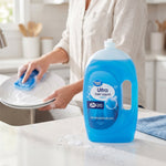 Great Value Ultra Dish Liquid bottle on a kitchen counter with person washing a plate in the background