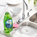 Great Value Ultra Dish Liquid bottle beside a sink with running water, sponge and dishes