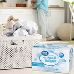 Lifestyle scene with laundry basket and Great Value Free & Delicate dryer sheets box placed on a light floor in a bright room