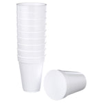 Stacked white foam cups with one cup laying on its side in front on a white background