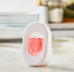 White oval Great Value Fresh N' Small air freshener device shown standing on a countertop with visible pink liquid refill.
