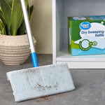 Close-up of a mop head with dirt on a Great Value dry sweeping cloth and the product box visible on shelf