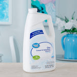 Great Value Oxy Carpet & Upholstery Cleaner jug staged on table in a light room with decorative background
