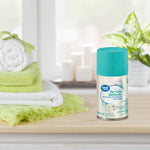 Single can of Great Value Pet Odor Eliminator air freshener on a wooden surface next to rolled towels and candles in bathroom setting.