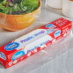 Great Value Plastic Wrap box on countertop with a covered bowl and sheet of plastic wrap partially unrolled nearby