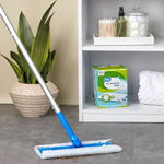Lifestyle scene showing a mop in use on floor with a Great Value dry sweeping refills box on a shelf