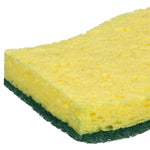 Macro angle of the yellow foam side of a green-and-yellow heavy duty scrub sponge on white background