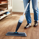 Lifestyle image of a person using a Great Value trigger spray mop on a wood floor