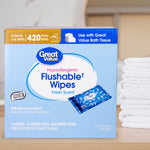 Great Value flushable wipes box displayed next to folded white towels on a shelf, showing package front
