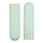 Two speckled pale green toothbrush travel case halves displayed vertically against a white background, showing rounded ends and hole.