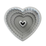 Light grey stacked scalloped heart bundt pan showing concentric tiers and central heart tube, overhead view