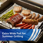Grill tray lined with Reynolds Wrap foil holding asparagus, ribs, sausages and other grilled foods