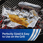 Grill scene with corn on the cob and a foil-wrapped item resting on crinkled aluminum foil over hot coals.