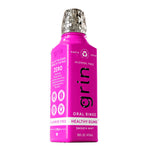 Three-quarter view of magenta Grin oral rinse bottle showing front and side labels.