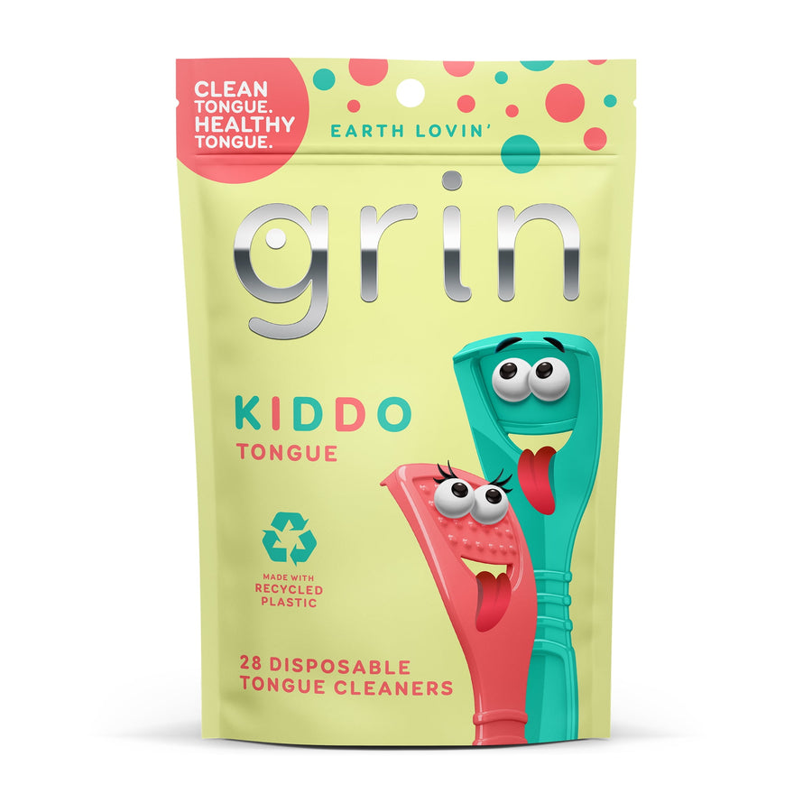 Front-facing pouch of Grin Kiddo tongue cleaners with playful cartoon scrapers and recyclation icon on pale yellow packaging.
