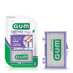 G·U·M Ortho Wax retail blister pack at left and a purple translucent wax case at right on white background.