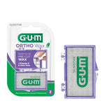 G·U·M Ortho Wax retail blister pack next to a detached purple translucent wax case on white background.