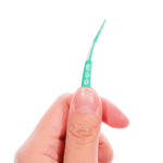 Hand holding a GUM Soft-Picks Advanced pick between thumb and forefinger against a white background